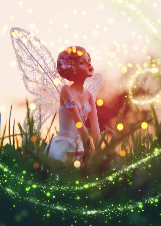 Fairy Light. foreground in green with glitter globes white and yellow orbs with a fairy dressed in white sitting in the grass with a starlit background